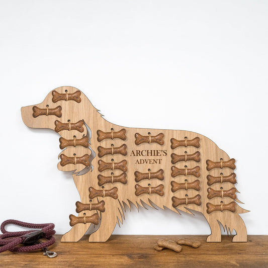 Spaniel-shaped oak advent calendar engraved "Archie's Advent" filled with bone treats